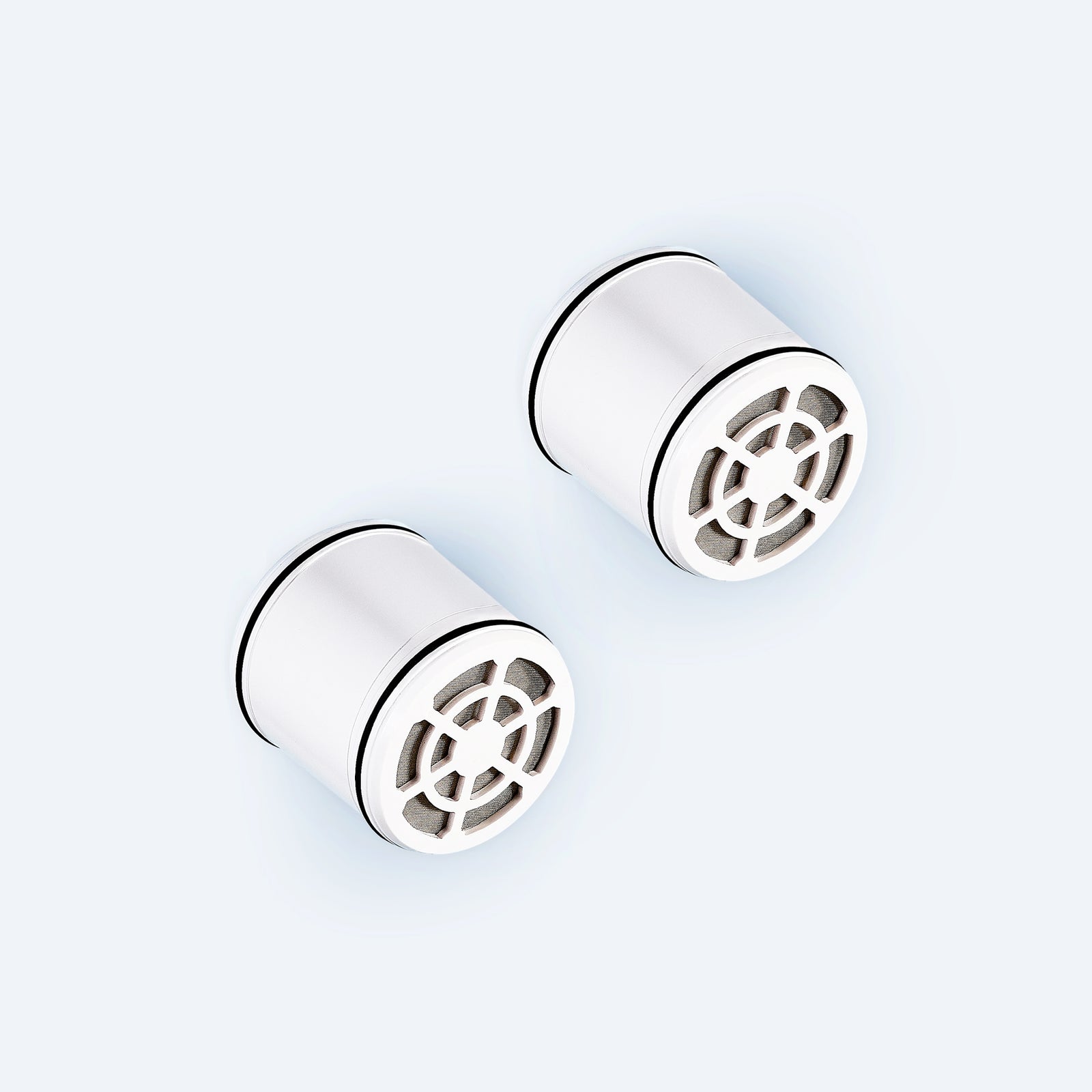 Photo of two Hydroviv showerhead replacement filters on light grey background