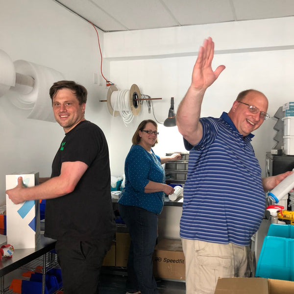 Dr. Eric Roy working on early Hydroviv filters with his parents. His dad waves with a smile on his face.