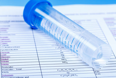 test tube with analytical laboratory results