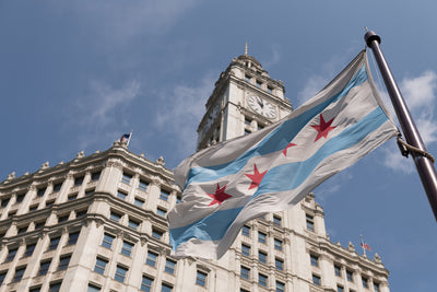 Chicago flag with building and blue sky in background