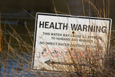 Health Warning sign in marsh