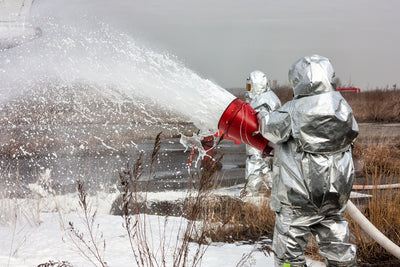 Firefighters spraying foam outside 