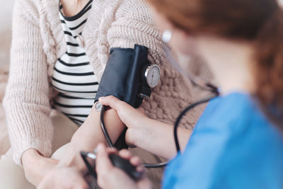 healthcare working taking patients blood pressure