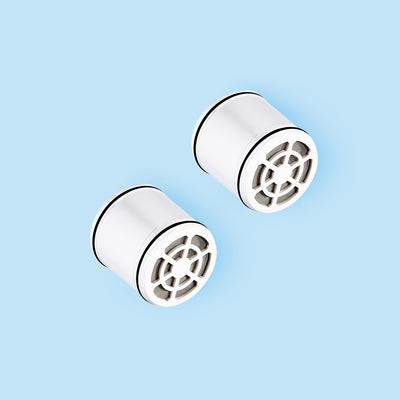 Photo of two Hydroviv showerhead replacement filters on blue background