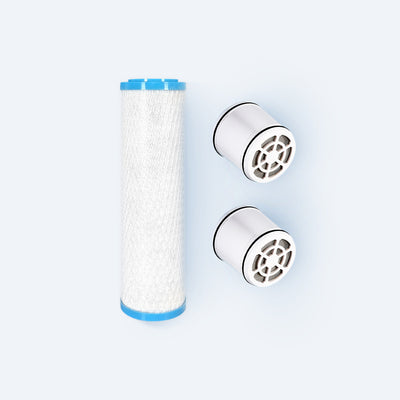 Photo of a replacement filter for the Hydroviv faucet filter and two replacement filters for the Hydroviv filtered showerhead on a grey background.