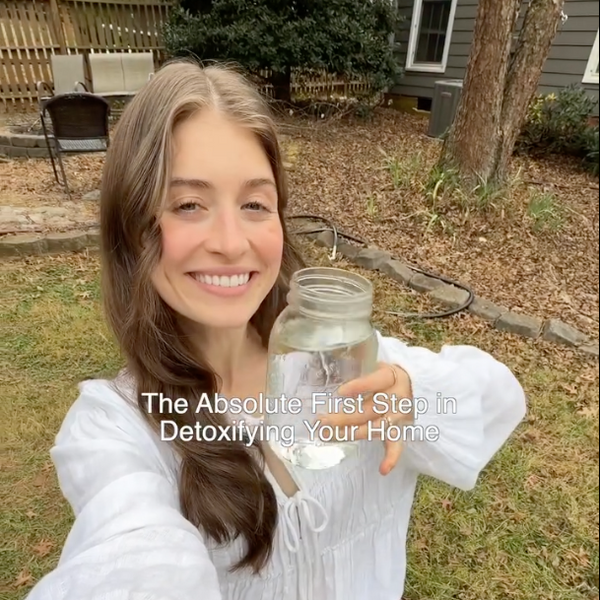 Person holding a jar outdoors with text overlay about home detoxification.